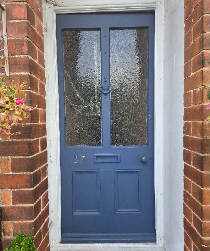 A poor quality blue front door